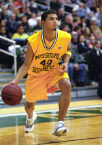 Hiram Ocasio, sophomore guard, dribbles at the 3-point line at the Jan. 18 game against Emporia State University. The Lions lost the game in overtime, 90-85.
