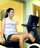 Brenda Torres, junior accounting and Spanish major, works out on a stationary bike machine in the Student Life Center. A new recreation center could be in the work in a couple years.
