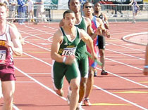 Chris Turner (back) hands the relay off to Moses Manga during the University of Kansas meet.
