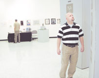 Don Greenlee, alumni, visits the senior art display in the Spiva Art Gallery.
