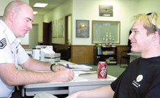 Air Force Sgt. Scott Self goes over paperwork with Jonathan Hardison, Joplin, who decided to join the Air Force and specialize in computers.
