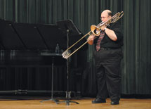 Low brass instructor, Dr. Jeffrey Macomber plays David AmramÂ´s Aritta during his April 18 recital in Webster Hall Auditorium. Dr. Cynthia Hukill also performed during the event.
