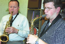 Dr. Charles Thelen (left) and Stephen Miller practice playing the saxophone. Miller recently had two of his saxophones stolen from the music lounge.
