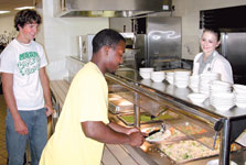 Jason Givens, senior undecided major, scoops up some food in the residence hall dining hall.
