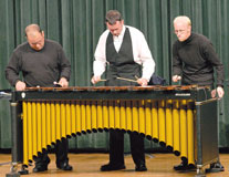 Damon Graue, left, Micah Martin and Josh Zimmer play Â´StubernicÂ´ by Mark Ford on the marimba. The piece utilizes the entire body of the instrument, including bars, frame and resonators. The piece is complex and the musicians rotate positions during the song.
