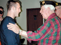 Ken LaNear, right, from VFW Post 113, talks with U.S. Army Pfc. Bandy Pease at a reception honoring him Oct. 13.
