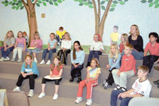 Children listen to Alejandra Burgess teach Spanish at the Joplin Library.
