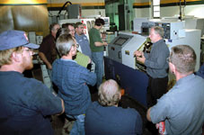 Don Schultz demonstrates to his Materials and Processes class the use of a metal lathe.
