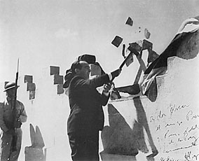 In 1948, José Figueres abolished the standing army of Costa Rica. This famous picture depicts Figueres in the symbolic action of destroying a portion of the military barracks.
