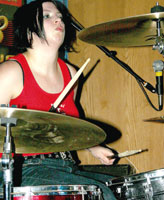 Mell Clark, drummer and back-up vocals, keeps fast-paced beat to the unique music.
