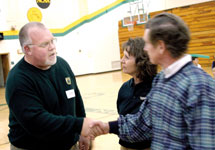 Head football coach John Ware talks with community members during a meet-and-greet session at Young Gymnasium, Jan. 17. Ware replaced former coach Bill Cooke in a nationwide search.
