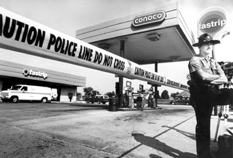 Sgt. Greg Francis, JPD, stands outside a barrier on Oct. 2, 1991, in front of the Fastrip at 1204 N. Duquesne Rd. where Lucinda J. Adams was murdered.
