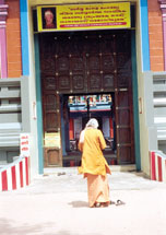 An Indian native takes off his shoes before entering the arched door of the mosque. Hinduism is the dominant religion of the country.
