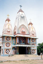 Andhra Pradesh is home of this colorful Catholic church. In this Church a mixture of Hindu and Catholic traditions can be seen. Inside, a statue of Jesus in an open lotus flower can be seen. The open flower represents immortality. Christianity first came to India with Thomas the Apostle.
