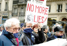 Tony Paschall, second from the left, marches with other members of Americans Against the War-France on March 20 in Paris. The bandanas worn by the members symbolize the Bush Administration. Protesters believe the Bush Administration is gagged from telling the truth to the American people.
