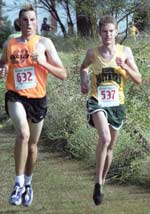 The LionsÂ´ Paul Koehler races against an OSU runner in the menÂ´s 8K race.
