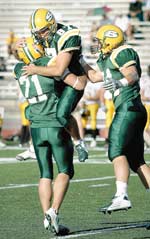 Teammates congratulate place kicker Brandon Hawkins after he kicked a 23-yard field goal with 22 seconds left on the clock in the last quarter of the Homecoming game against Missouri Western State College. Hawkins along with teammate Moses Manga earned MIAA players of the week.

