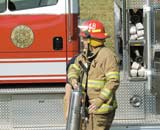 Joplin firefighter Dave Holden caries a fire extinguisher into Spiva Library Oct. 16. A bearing seized up in an air exchanger causing the grease around it to heat up adn begin to smoke. The smoke set off a detector in the duct system.
