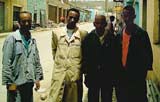 Kimfe Kidane (second from left) and his coworkers stand outside KidaneÂ´s furniture shop where they have all started their new lives in Ethiopia after leaving Eritrea.

