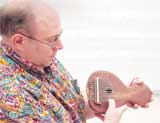 Dr. Jeffrey Macomber demonstrates mbiroa, an African thumb piano used in the upcoming class.
