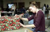 Jennica Sorensen, senior music major, wraps gifts for her family and friends during the Dec. 7 wrap-up party at the Student Life Center.
