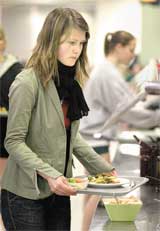 Swedish exchange student Cecilia Aolfssom serves herself a vegetarian meal at the salad bar in the cafeteria. I would like to have more variety but I like the food theyÂ´re serving, Adolfssom said.
