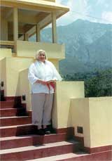 Standing outside the home of Karma Pa at Sidh Bar, is Dr. Carolyn Hale, professor of communication. The home is a monastery.
