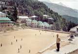 Thupton Dorjee stands above a group of Tibetan children playing soccer in the TCV.
