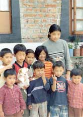 A group of Tibetan children stand oustide their home in the Tibetan ChildrenÂ´s Village. The home is one of around 40 in the village.
