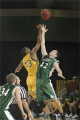 Orestus O.C. Cavness jumps for the tip-off against NWMSU Bearcats during the break.
