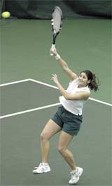 Barb Gombosi, sophomore, returns a hit during a set against Emporia State at Millenium Tennis and Fitness Center Sunday.
