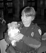 Animal control officer Pam Paxton cradles Poohder, a Yorkie.
