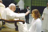 Anna Baker, senior psychology major, receives a silent blessing from the late John Paul II.

