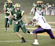 Dustin Bromley, senior wide receiver, makes a move around a Bearcat defender during the Sept. 10 game at Hughes Stadium.
