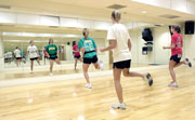 Courtney Tate, senior health promotion and wellness major, left, leads her students in aerobics routines.
