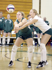 Amy Barnicle, junior libero, and Megan Norman, junior libero, both go for the ball during the Sept. 28 game.

