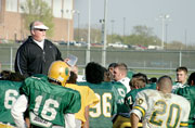 John Ware talks to the football team after a practice April 13, 2004. He was beginning training for his first year as head coach. Ware died Sept. 27.
