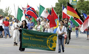 International students unite together as they march during the Homecoming parade Oct. 1. The students each wore ensemble which symbolized their different cultures.
