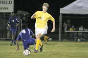 Neil Stoessel, sophomore midfielder/forward, dribbles past a defender in the Oct. 14 game.
