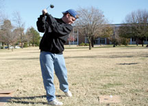 Nathan Beasley, freshman sociology major, demonstrates how to golf with a wiffle ball for a Kappa Sigma member drive Nov. 16.
