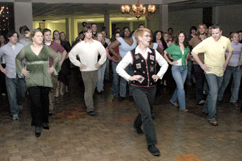 Judy Schneider, kinesiology instructor, leads a traditional Russian dance on Dec. 2 in the Connor Ballroom.
