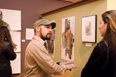 Jeff Youngblood, junior studio art major, (left) describes his artwork to Adrienne Huser, freshman mathematics and Spanish major.
