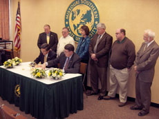 Southeast Missouri State University President Kenneth Dobbins (seated, right) signs a cooperative masters degree program in criminal justice with University President Julio Leon Feb. 17. After the Coordinating Board for Higher Education approves the agreement, classes will begin as soon as the fall semester.
