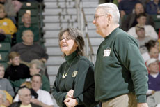Lee Pound escorts Fred Daugherty, JuCo alumni during the half-time recognition on Feb. 18.
