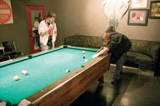 Joplin High School students Taylor Kennedy (right) and Cody Wright play pool at the Salvage Yard.
