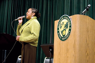 Monique Canada, sophomore biology major, sings during the 14th annual Langston Hughes Celebration.
