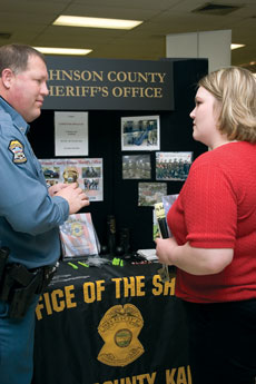 Deputy Sheriff Whisenhunt, left, Johnson County Sheriffs Office, helps Jennifer McBroom, junior criminal justice major, during the Job Expo March 8.
