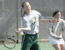 Sophomore Michelle Hall tips the ball over the net during a doubles match March 26.

