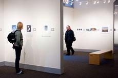 Anna Hallin, photography major, and professor Orjan Henriksson, professor of photography, both from Folkhogskola looks at the PhotoSpiva exhibit at the Spiva Center for the Arts.
