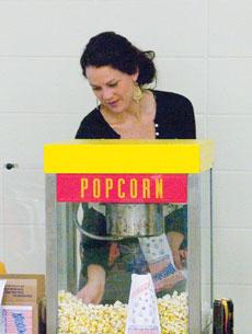 Lisa Andersson, communications major from Sweden, serves popcorn at the Study Abroad Fair Nov. 15 in the Billingsly Student Center.
